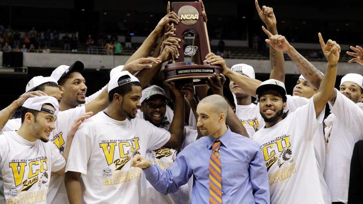 VCU players raise the regional trophy after beating Kansas in the 2011 Elite Eight in San Antonio. The Rams became the first team to reach the Final Four by winning five games.