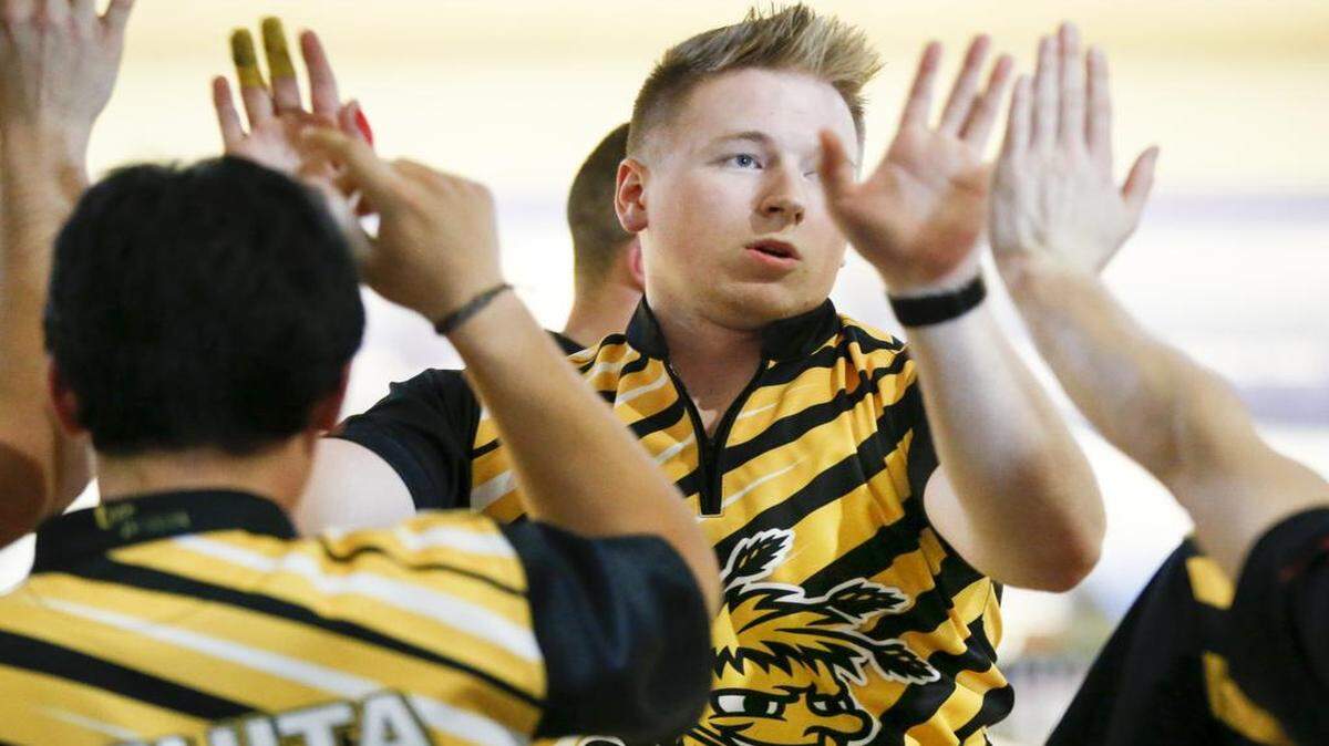 
A.J.Chapman accepts congratulations after a strike during the Wichita State men’s team’s win over Clarke University during match play Thursday at Northrock Lanes.
