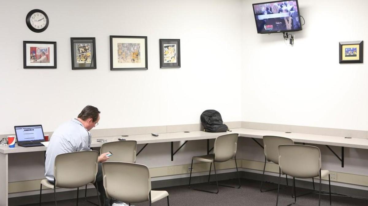 Wichita State basketball coach Gregg Marshall checks his phone and watches the NCAA selection show in the media room after it was announced that the Shockers are in the NCAA Tournament for a fifth straight season.
