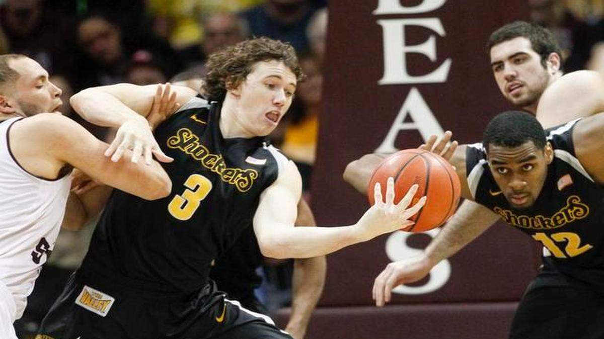 
Wichita State's Evan Wessel fends off Missouri State's Camyn Boone as he collects a loose ball earlier this season.
