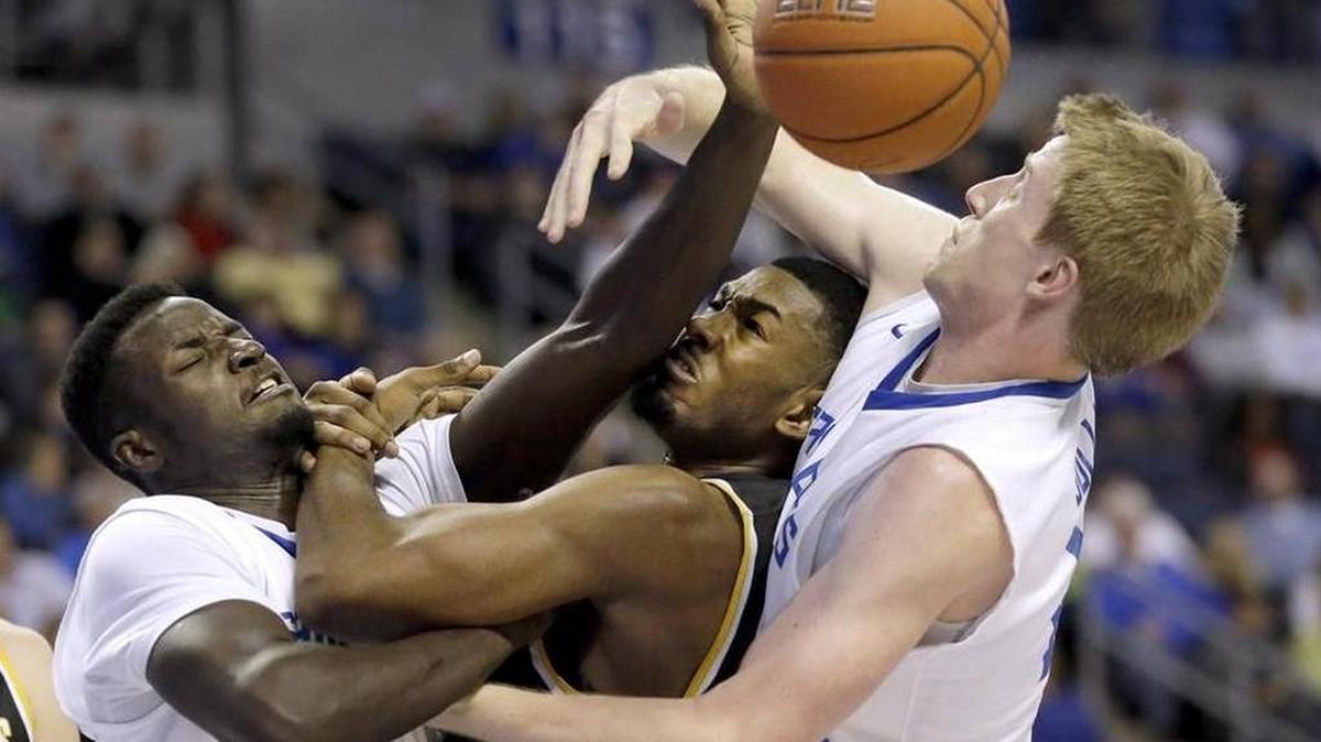 Wichita State's Rashard Kelly, center, is caught between Saint Louis' Reggie Agbeko, left, and Brett Jolly while trying to grab a rebound during the first half Saturday in St. Louis.