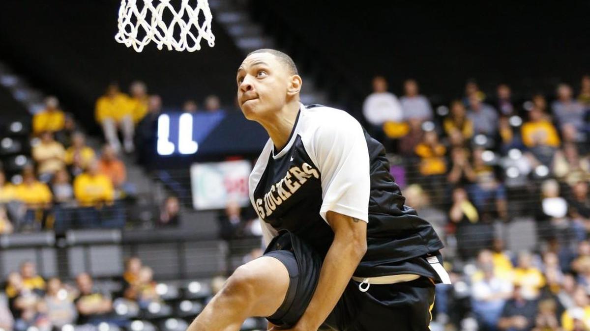 Wichita State's C.J. Keyser goes through the legs during the dunk contest at Shocker Madness in Koch Arena last season.