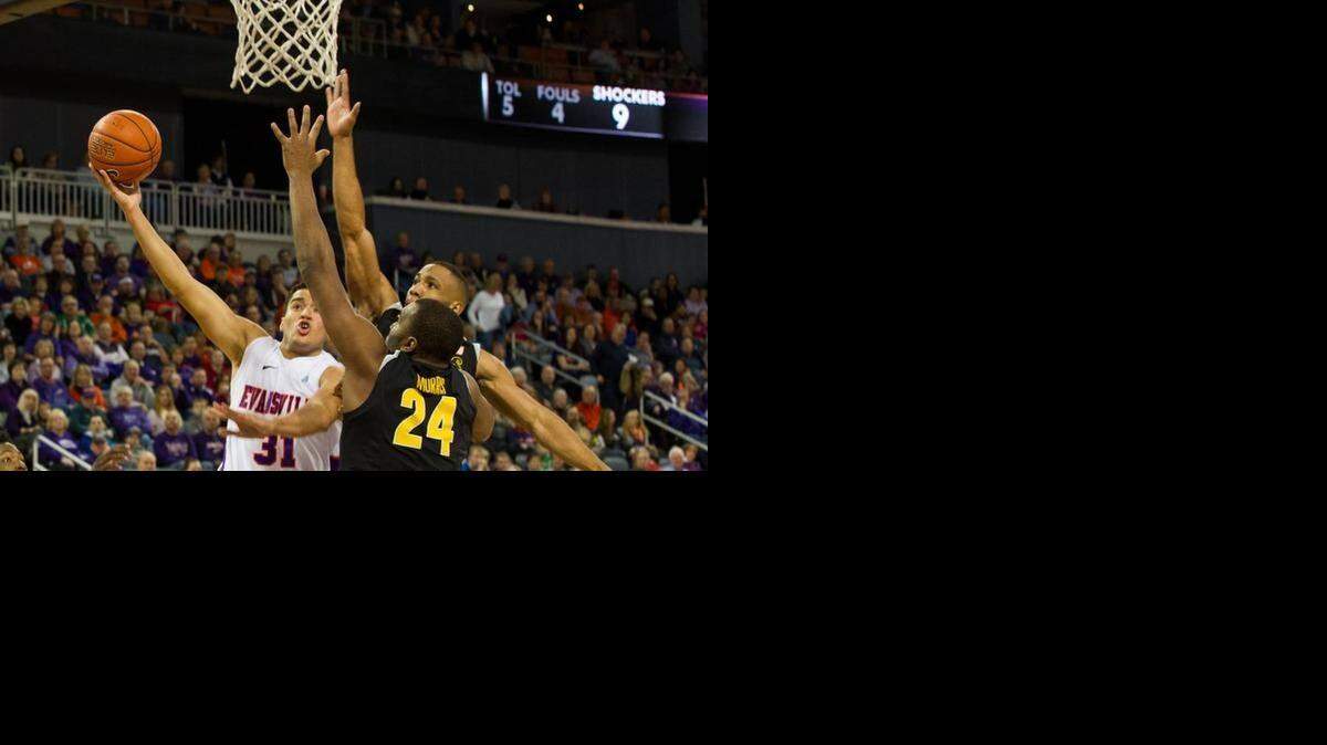
Wichita State’s Shaq Morris (24) and Tekele Cotton guard Evansville’s D.J. Balentine during Saturday’s game at the Ford Center.
