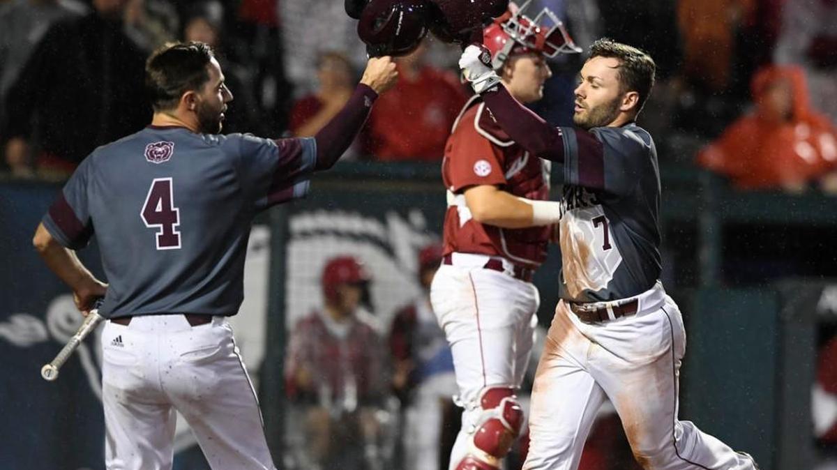 Missouri State’s Logan Geha (4) greets teammate Hunter Steinmetz (7) after a two-run home run in the 9th inning against Arkansas during an NCAA regional on Sunday.