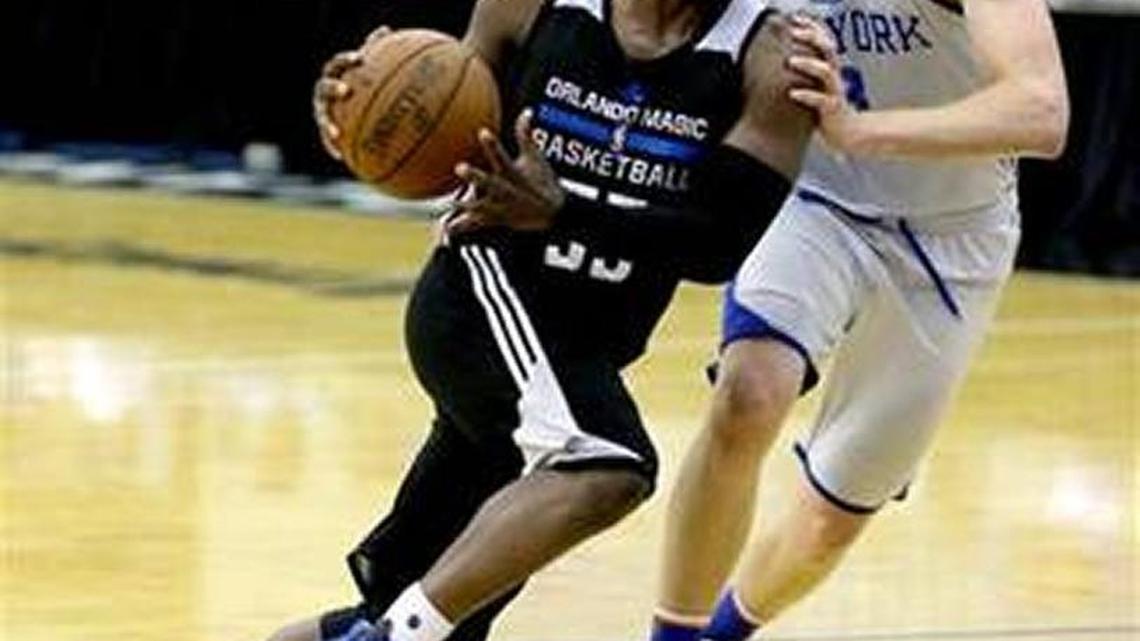 Ron Baker guards Orlando’s Justin Dentmon during a game in the Orlando summer league.