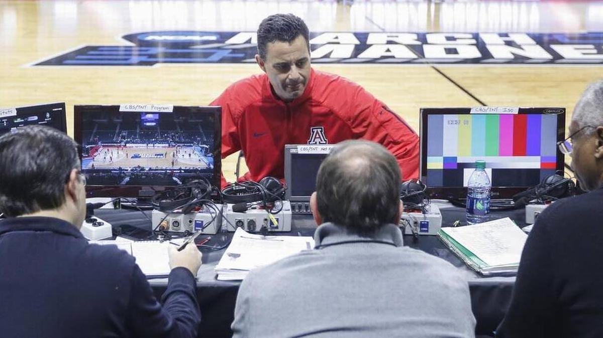 Arizona coach Sean Miller talks with TV people on Wednesday at the Dunkin’ Donuts Center.