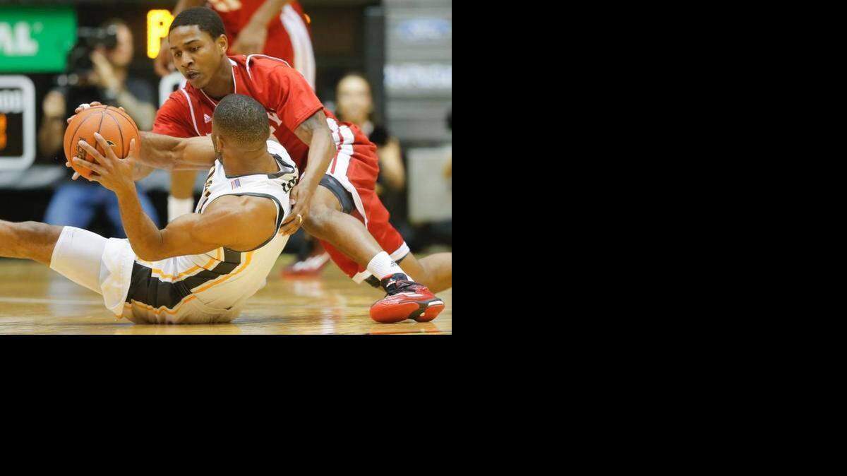 
Bradley guard Tramique Sutherland tangles with Wichita State’s Tekele Cotton during a Jan. 7 game at Koch Arena.
