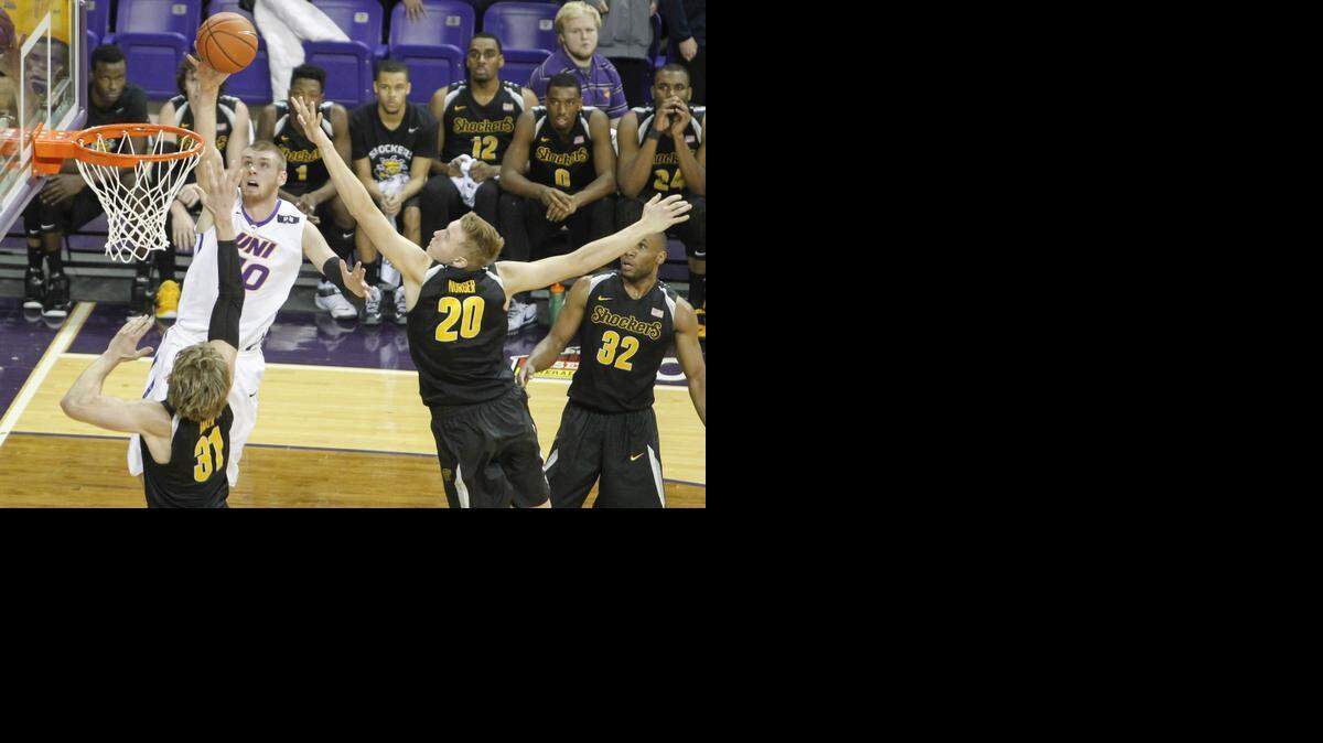 
Northern Iowa’s Seth Tuttle shoots over Wichita State's Ron Baker, bottom left, at the McLeod Center in Cedar Falls, Iowa, on Jan. 31, 2015. Northern Iowa won, 70-54. 
