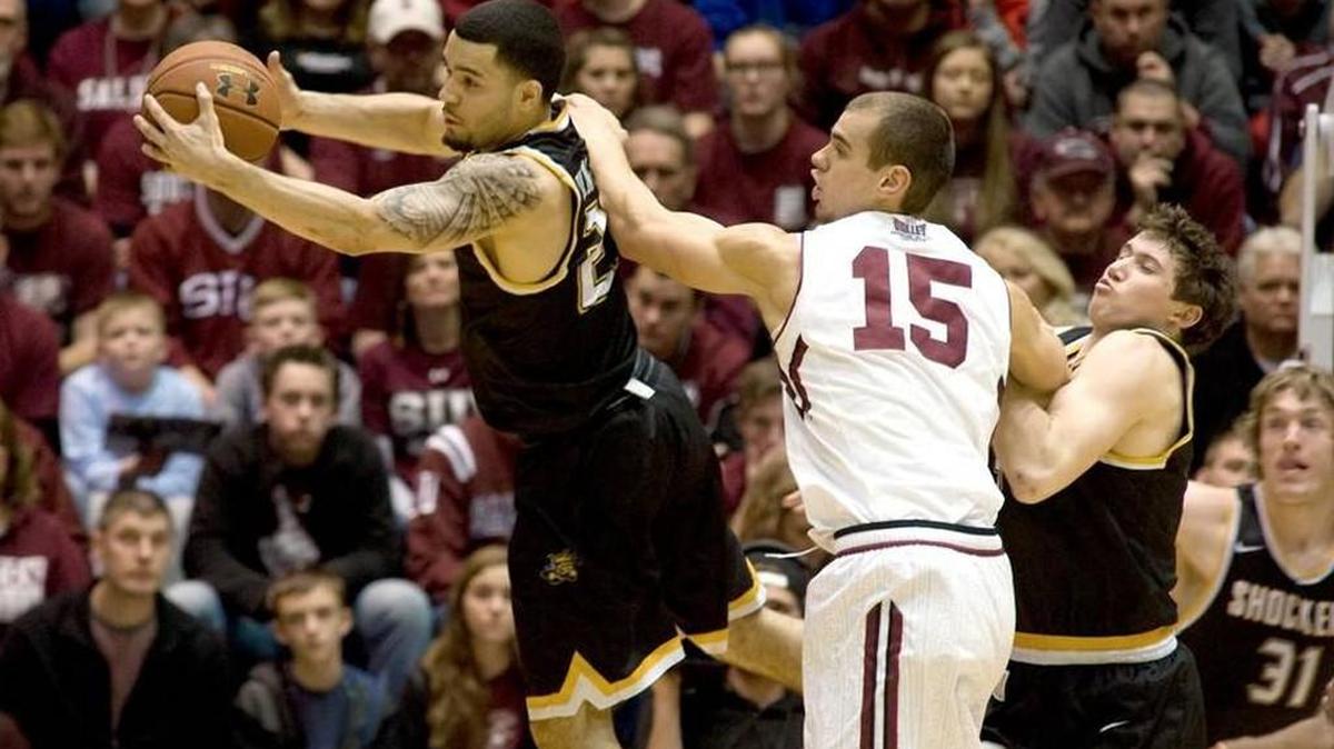 Wichita State's Fred VanVleet grabs a rebound away from SIU's Austin Weiher in the first half.