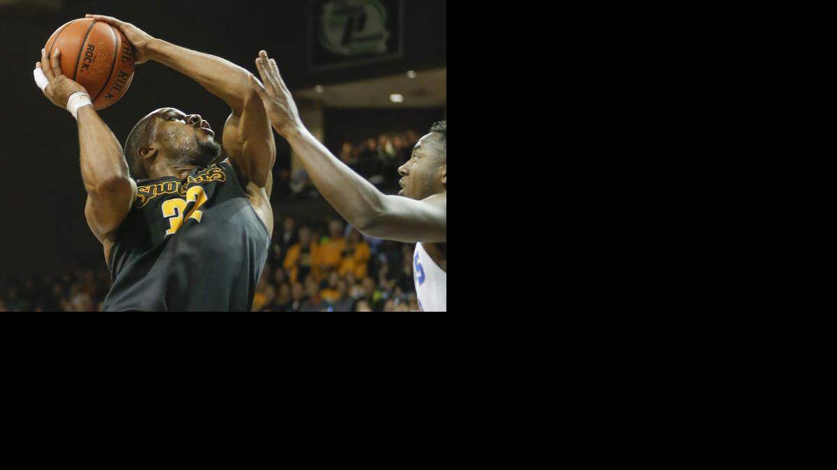 
Wichita State’s Tekele Cotton goes to the basket against Memphis’ Avery Woodson during the first half Tuesday in Sioux Falls, S.D.
