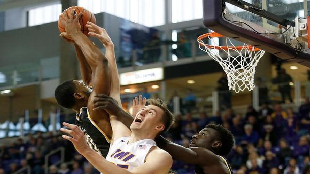 Northern Iowa's Bennett Koch fights for a rebound against Wichita State's Rashard Kelly and Eric Hamilton, right, during the first half.