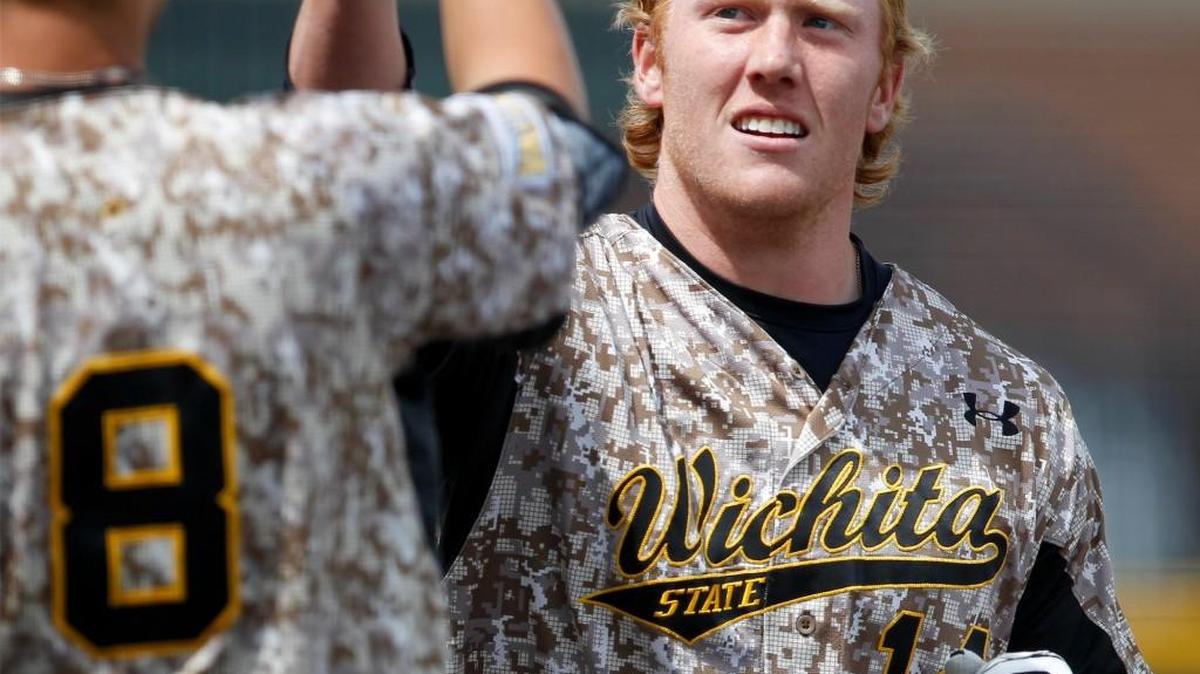 Wichita State’s Gunnar Troutwine, right, gets congratulated on his first college home run of his career last April.