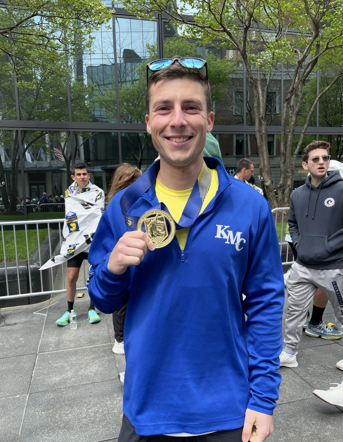 Father Seth Arnold, a Wichita native and Kapaun Mt. Carmel chaplain, holds his medal after running the Boston Marathon in 2 hours, 35 minutes, 45 seconds.