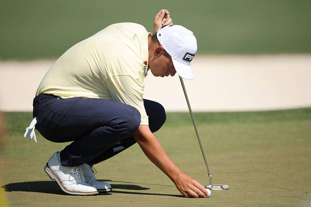 Sam Stevens, a 2014 Kapaun Mt. Carmel graduate, looks over a putt on the second hole during the final round of the Masters on Sunday.