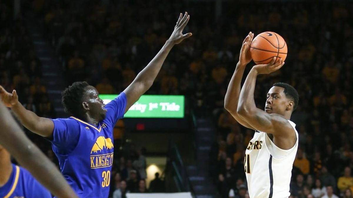 Darral Willis hits a three-pointer over UMKC’s Aleer Leek during WSU’s win on Nov. 10.