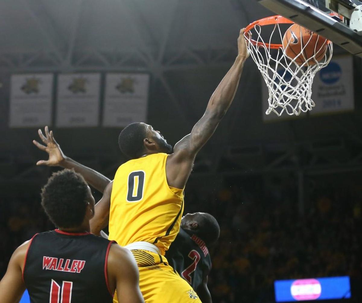 Wichita State forward Rashard Kelly dunk over Arkansas State forward Salif Boudie.
