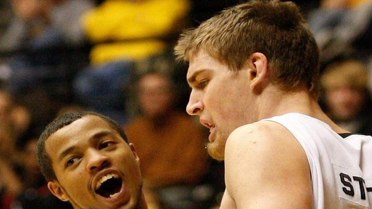 Clevin Hannah, left, and Garrett Stutz are Wichita State basketball alums who have made a living playing professionally overseas. “Unless you are this close (to the NBA) or a team promises you … the money overseas is so much better,” Stutz said.