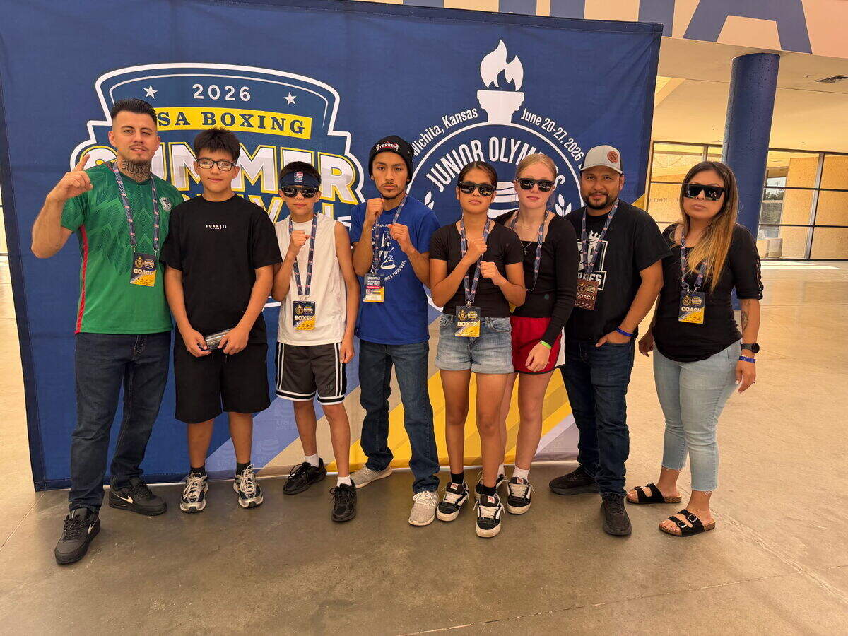 Torres Boxing Academy qualifiers Arayiah Cassidy, Luciano Rodriguez, Alvin Torres Jr. and Liliana Torres pose with coach Alvin Torres Sr. and his wife, Sandy Torres, far right, during the USA Boxing National Junior Olympics in Wichita.