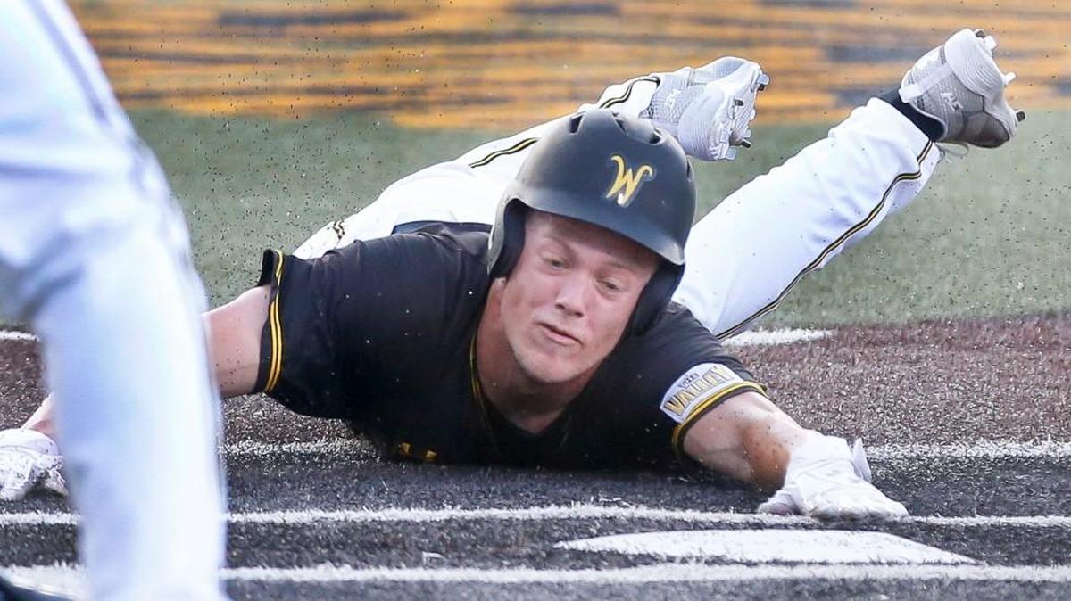 Wichita State's Greyson Jenista dives into home against Kansas last month.