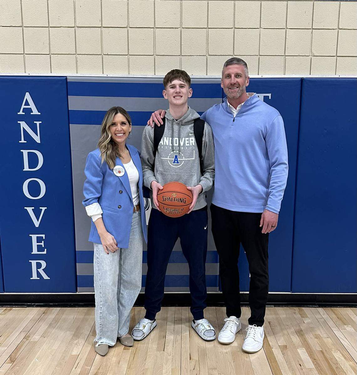 Andover senior Brendan Eilert with his parents, Brandi and Josh, on senior day for Andover boys basketball.