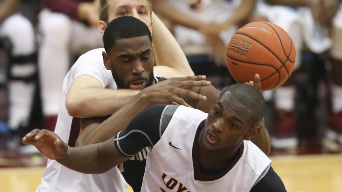 Wichita State's Rashard Kelly gets tangled between Loyola defenders during the first half Sunday at Loyola's Gentile Arena.