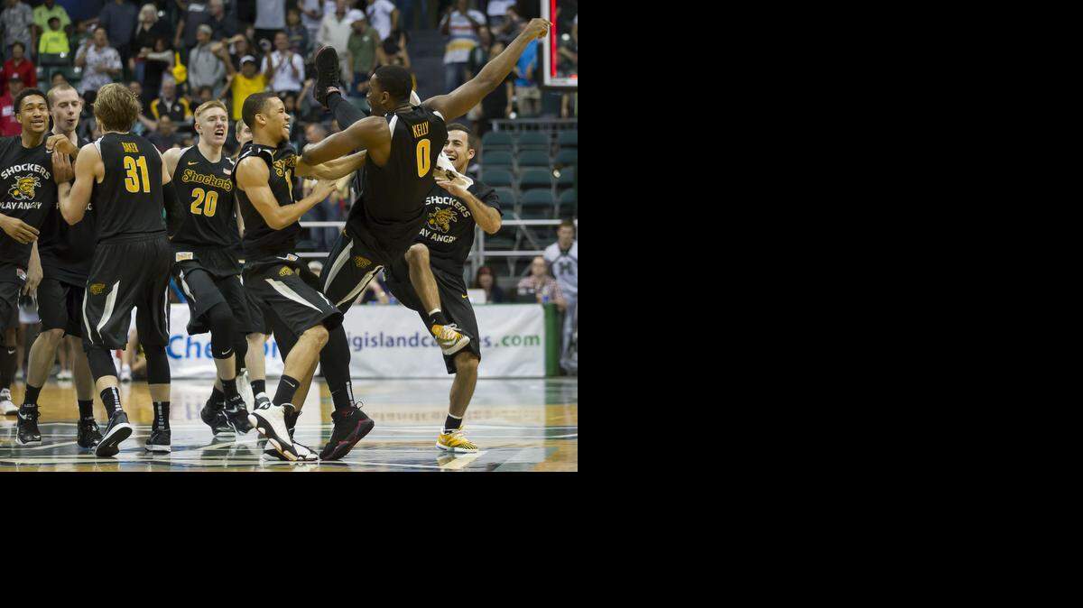 
Wichita State forward Rashard Kelly (0) is surrounded by his teammates after an NCAA college basketball game at the Diamond Head Classic on Tuesday in Honolulu. Wichita State celebrates defeating Hawaii 80-79 in overtime and advances to the finals of the tournament.
