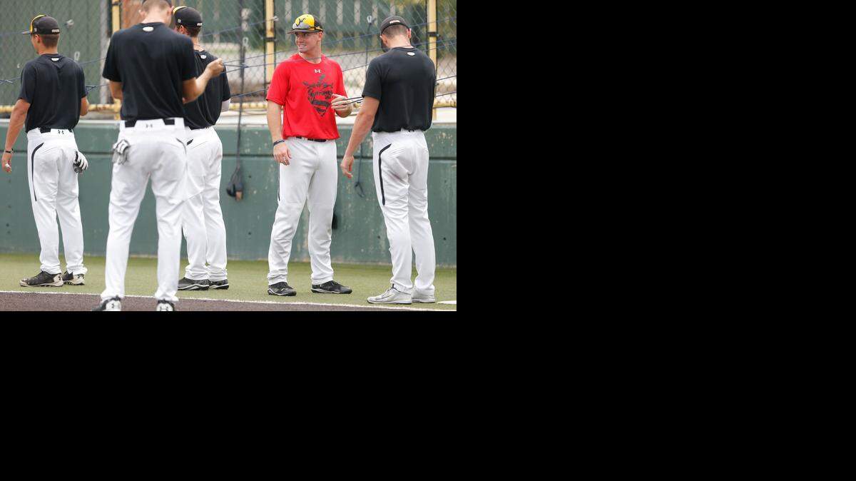 
Wichita State baseball player Daniel Kihle wears a special red practice shirt, signifying the best practice players during that week. The shirts honor former Shocker Carl Hall with his number on the back and former Shocker Mitch Caster with his initials on the sleeve. 
