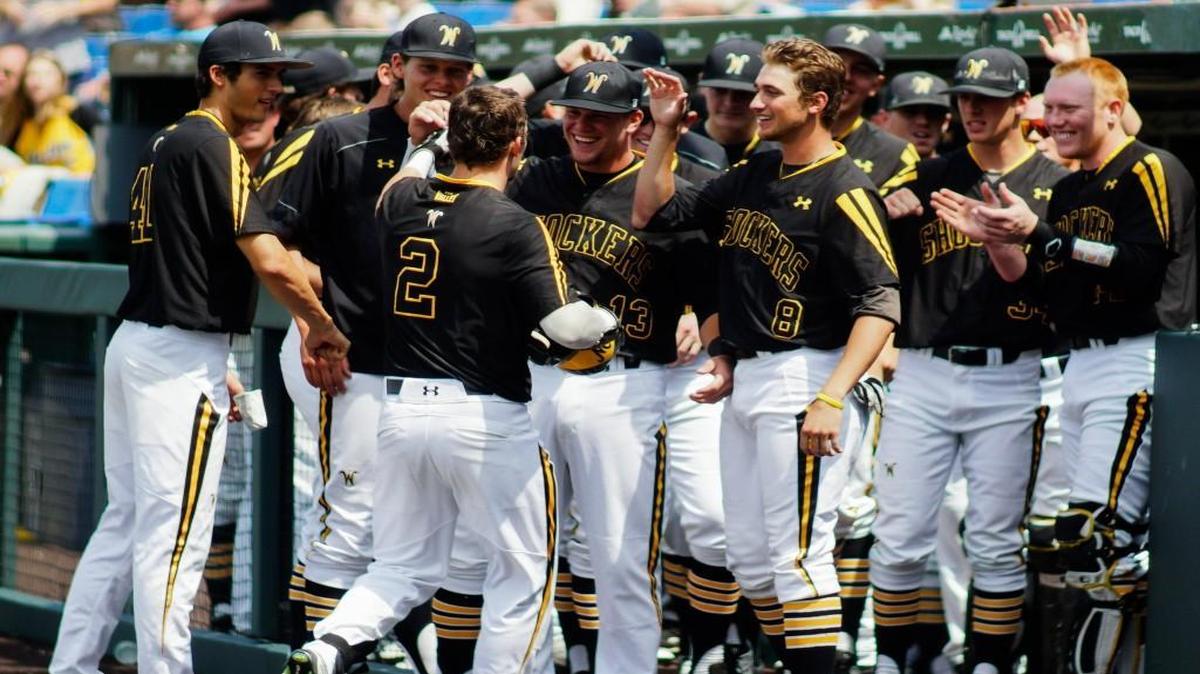 Shocker teammates greet Tanner Kirk (2) after his home run against Dallas Baptist on Saturday afternoon at Eck Stadium