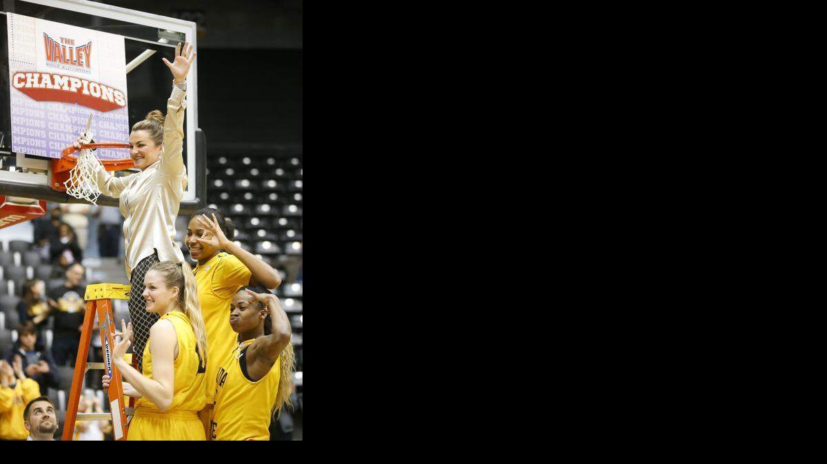
Wichita State head coach Jody Adams cuts down the net with her three seniors Kelsey Jacobs, bottom left, Jamillah Bonner, bottom right and Alex Harden. The team clinched at least a share of the conference title after beating University of Northern Iowa 66-54. They are holding up three fingers because it's the third consecutive conference title for the team. (March 1, 2015)
