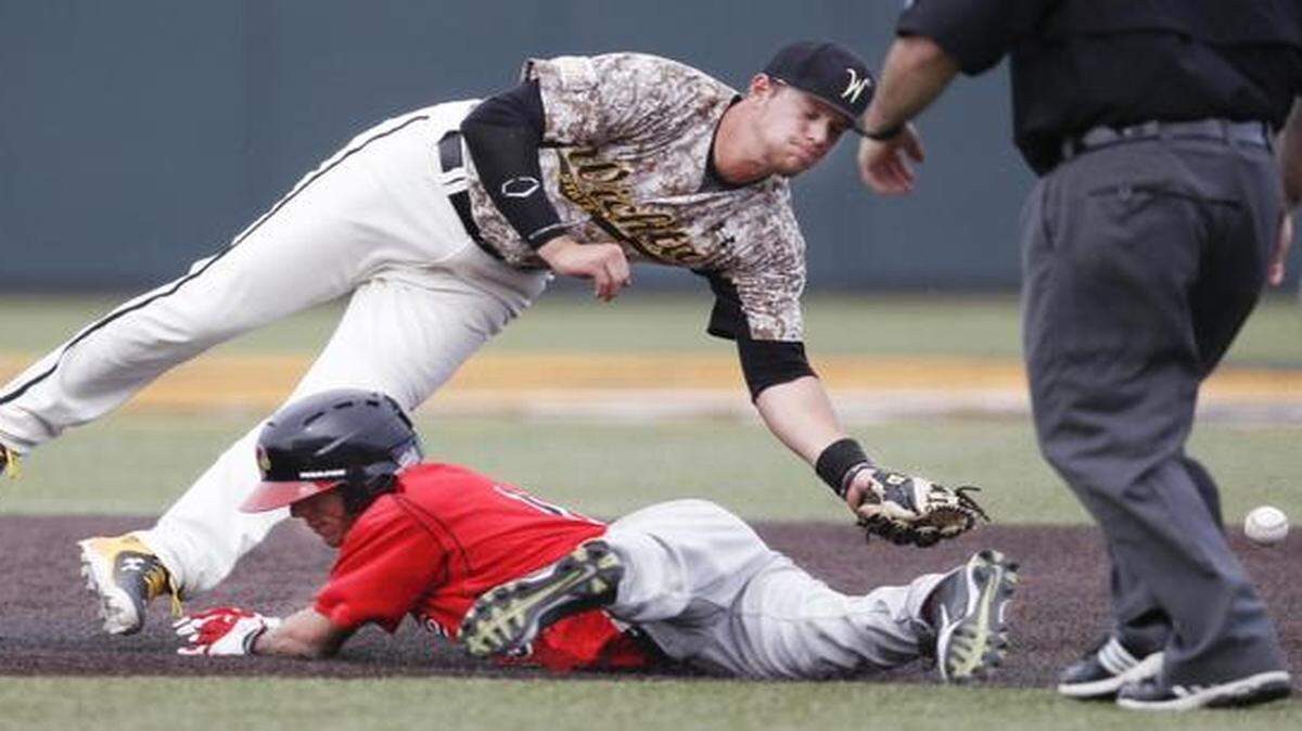 
Wichita State's Chase Radar can't catch a throw as Illinois State's Jared Hendren steals second base in the eighth inning Saturday at Eck Stadium Saturday.
