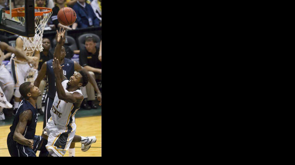 
Wichita State forward Zach Brown (1) shoots a layup while being defended by Loyola Marymount forward Patson Siame (14) in the second half of an NCAA college basketball game at the Diamond Head Classic on Monday, Dec. 22, 2014, in Honolulu. Wichita State beat Loyola Marymount 80-53.
