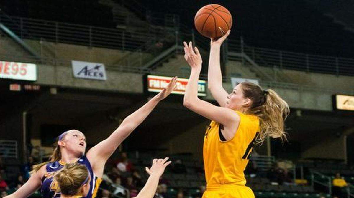 
Wichita State’s Kelsey Jacobs goes up for a shot over two UNI players during the first half Saturday at the MVC Tournament in St. Charles, Mo.
