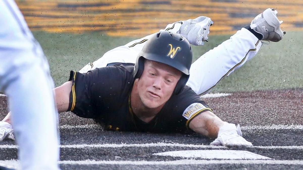 Wichita State's Greyson Jenista dives into home last season against Kansas. Jenista is one of two Shockers projected to be early-round draft picks this summer.