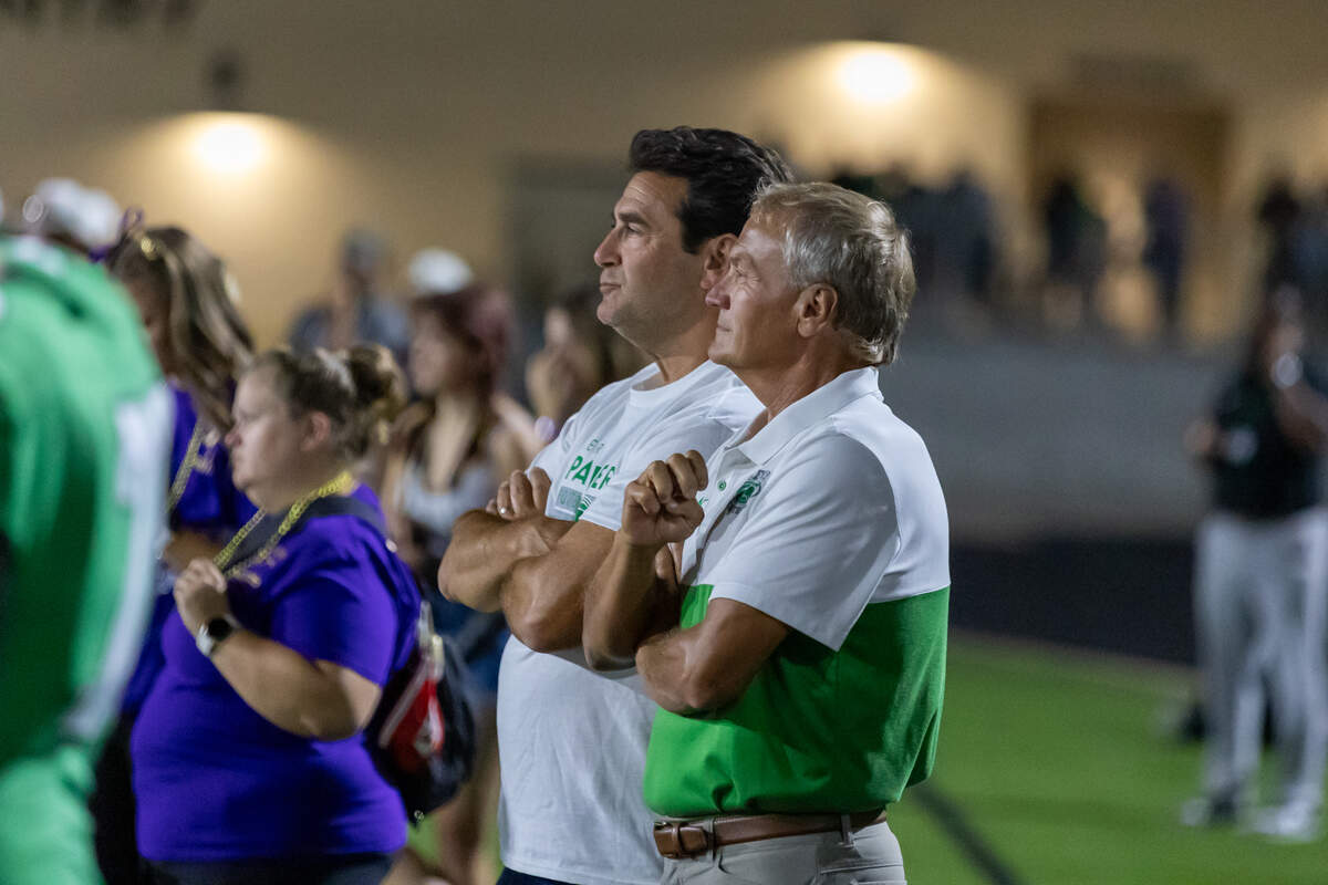 Dave Gordon (left) and Kevin Chase (right) watch a Derby football game together during last season. The duo teamed up with Derby football coach Brandon Clark to write the book “Culture Champion.”