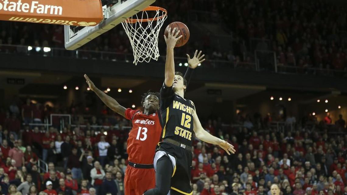 Wichita State guard Austin Reaves makes a layup over Cincinnati forward Tre Scott in the final seconds Sunday at BB&T Arena in Highland Heights, Ky.