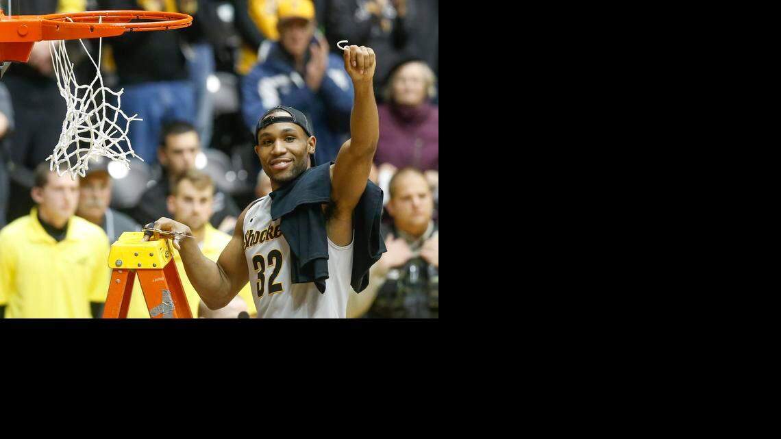 
Wichita State senior Tekele Cotton holds up a piece of the net after the Shockers defeated Northern Iowa on Saturday.
