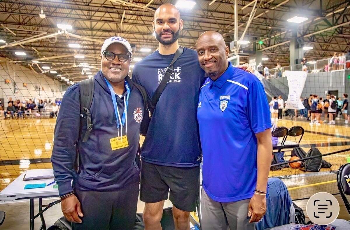 River City Hoops founder Van Williams, left, former Wichita Heights standout Perry Ellis, center, and Team PE 34 coach Tyrone Berry pose for a photo during the Wichita AAU team’s summer season.