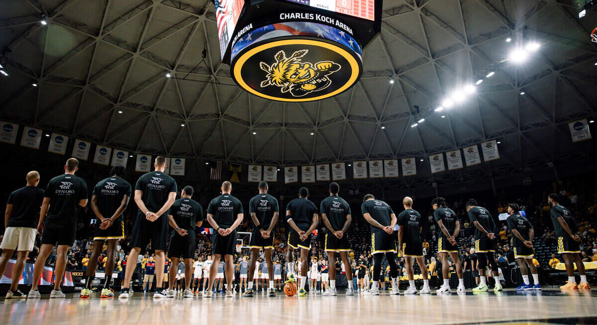 The AfterShocks stand in line before a game in The Basketball Tournament with their pregame shirts sponsored by Dynamo Capital with the company’s griffin on the back.