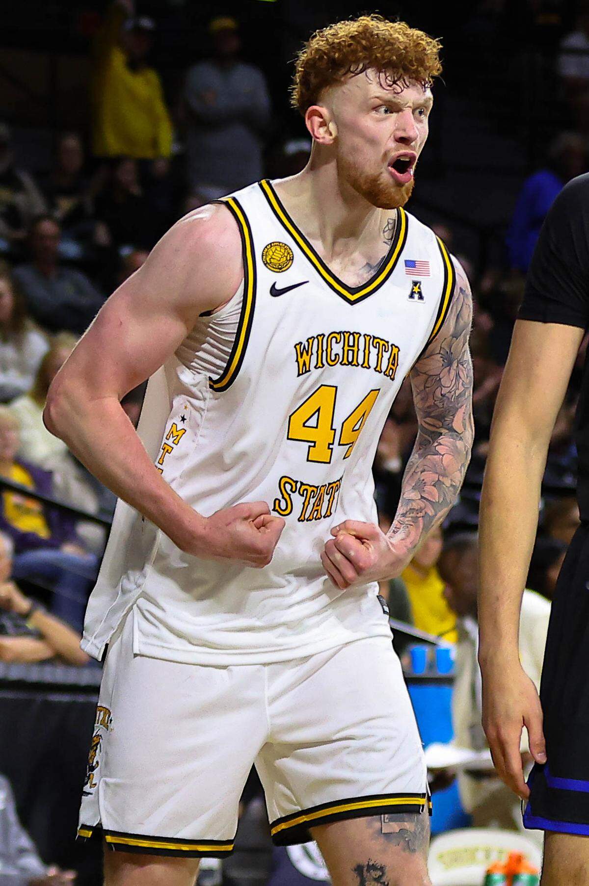 Wichita State center Will Berg flexes in celebration after a basket and a foul in a win over UNC Asheville at Koch Arena.