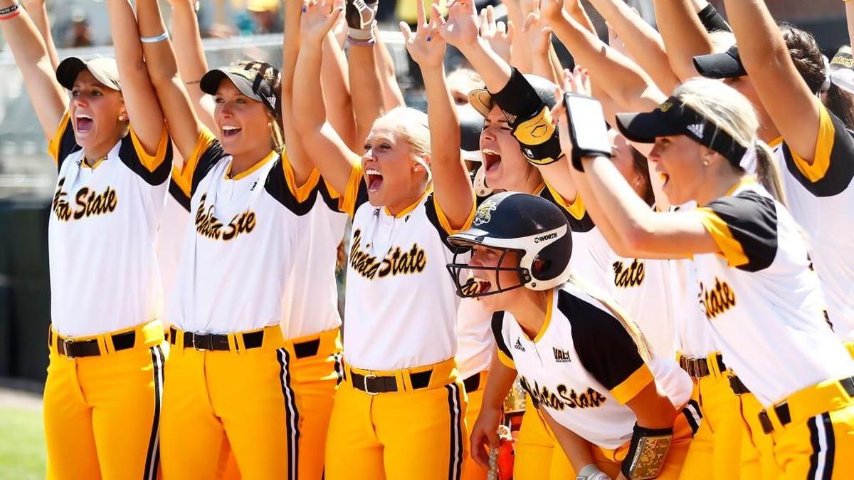 The Wichita State team waits to greet Cacy Williams at home after Williams hit a home run earlier this season at Wilkins Stadium.