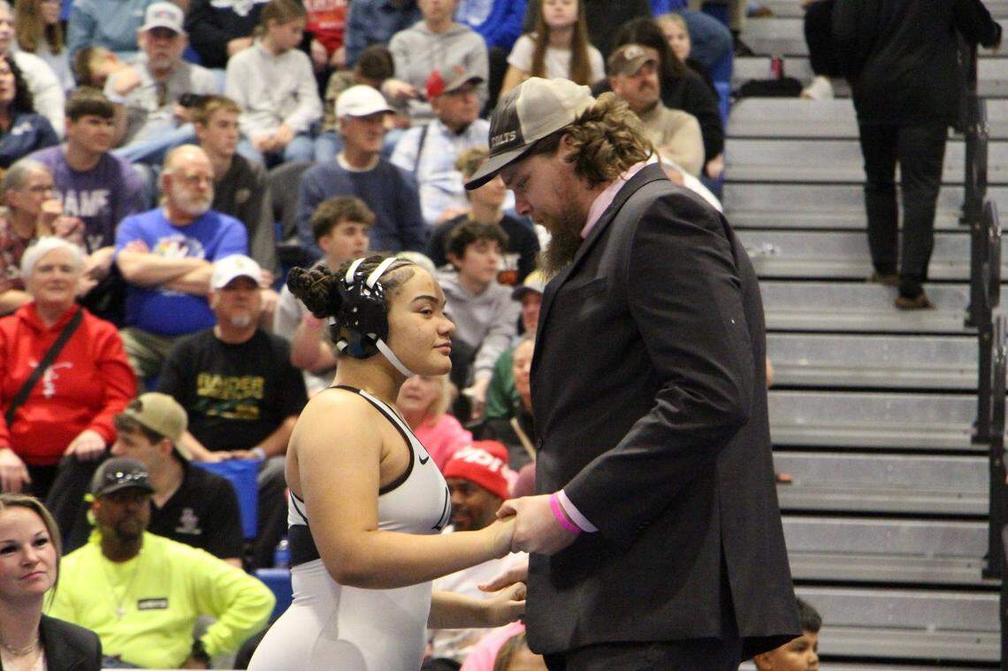 Campus junior Elayna Evans meets with coach Jake Allan before her state championship match.