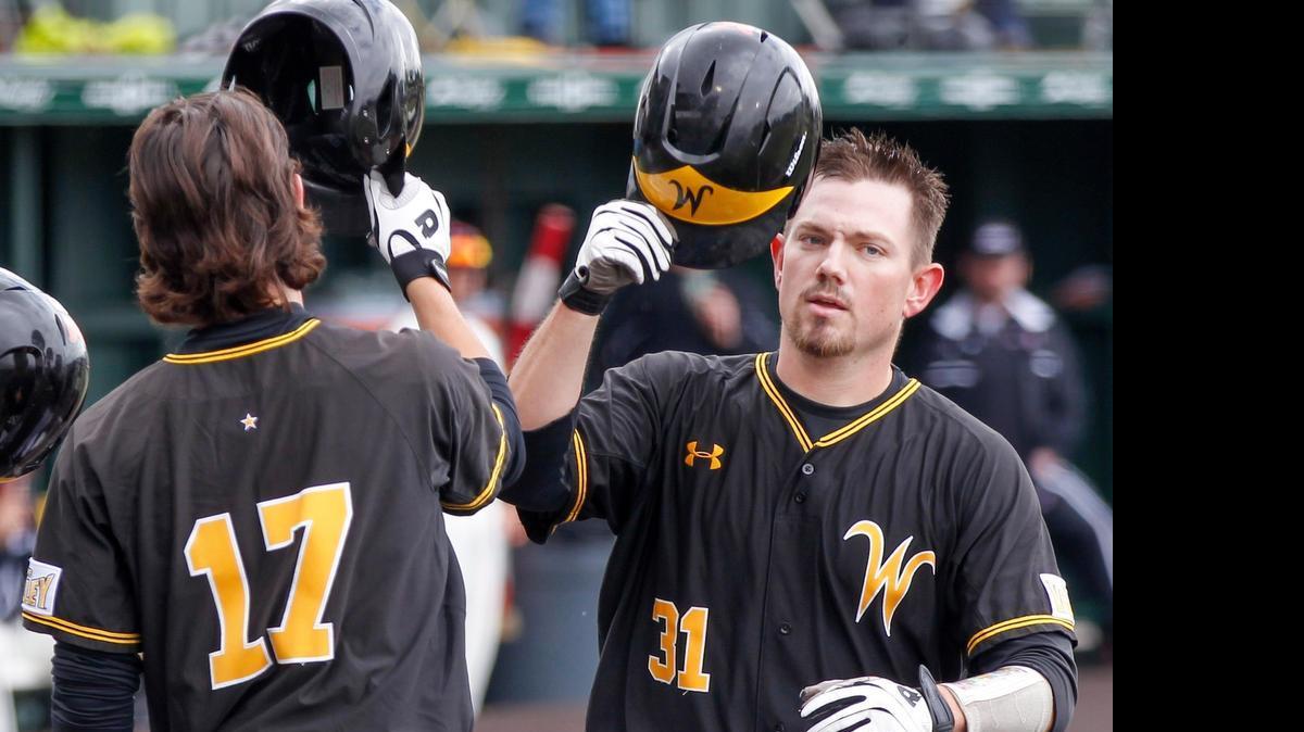 
Wichita State's Bob Arens (31) gets congratulated by teammate Trey Vickers (17) after his two-run homer in the MVC tournament last month. The tournament moves to Indiana State in 2016.
