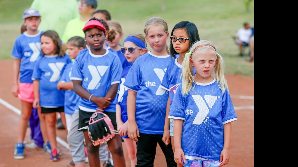 
The Superspeed softball team listens to the oath of good sportsmanship before a recent softball game with the Strikers at the North YMCA. 
