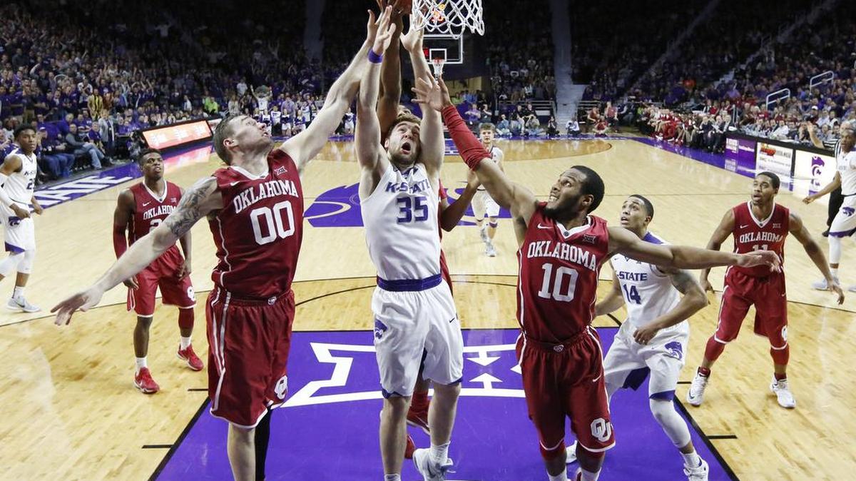 K-State forward Austin Budke (35) reaches for rebound surrounded by Oklahoma players as K-State took on #1 ranked Oklahoma. (February 6, 2016)