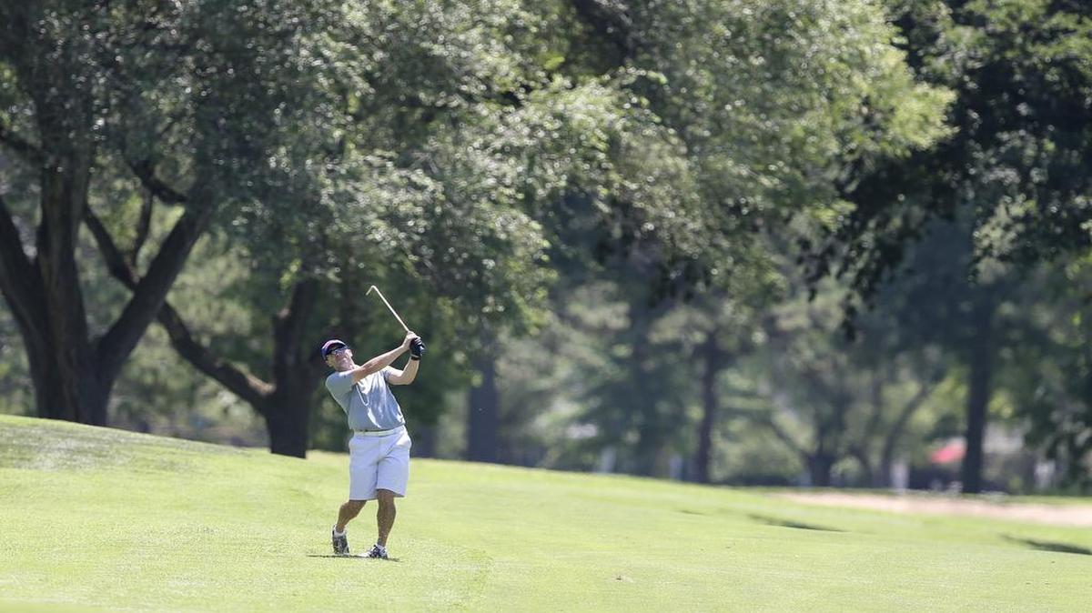 
Conrad Roberts hits his approach onto the 16th green on Thursday during Kansas Amateur tournament at the Wichita Country Club. 
