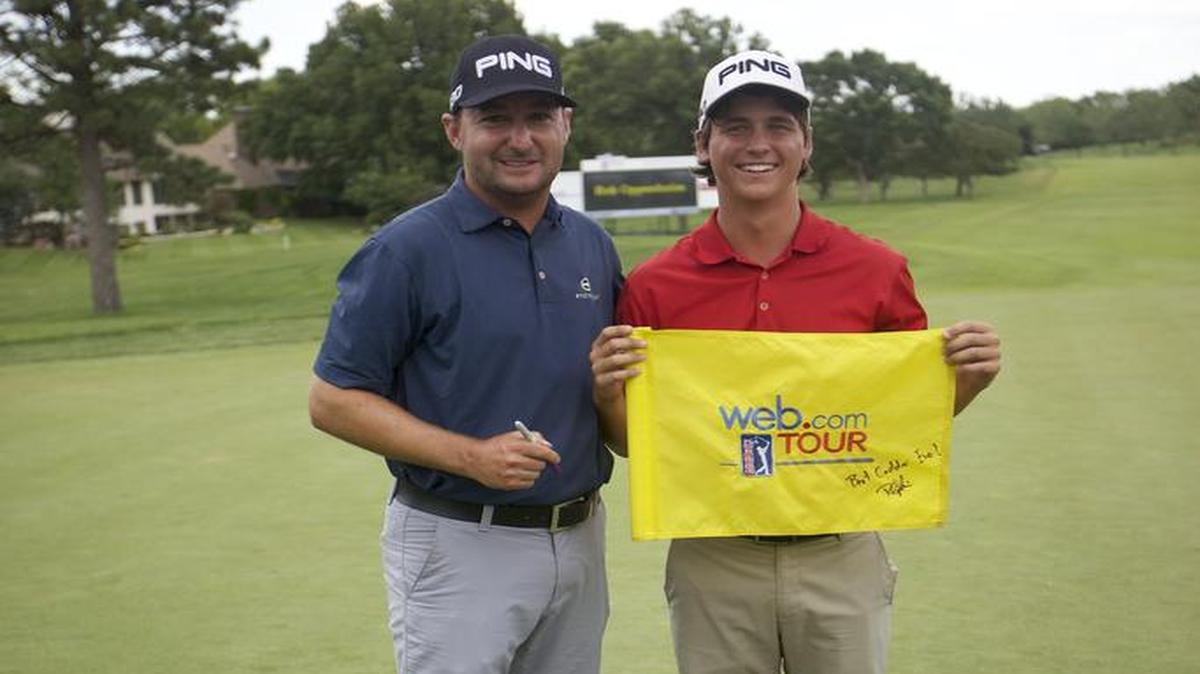 
Rob Oppenheim signs a Web.com tournament flag for his caddy, Eric Ewers, after winning the Air Capital Classic at Crestview Country Club Sunday afternoon. 
