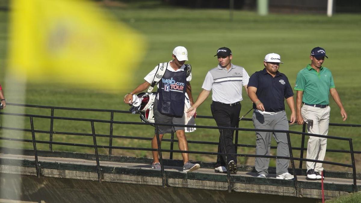 
Ryan Spears, Vince India and Matt Atkins walk across the bridge on No. 7 during the second round of the Air Capital Classic at Crestview Country Club Friday afternoon. 
