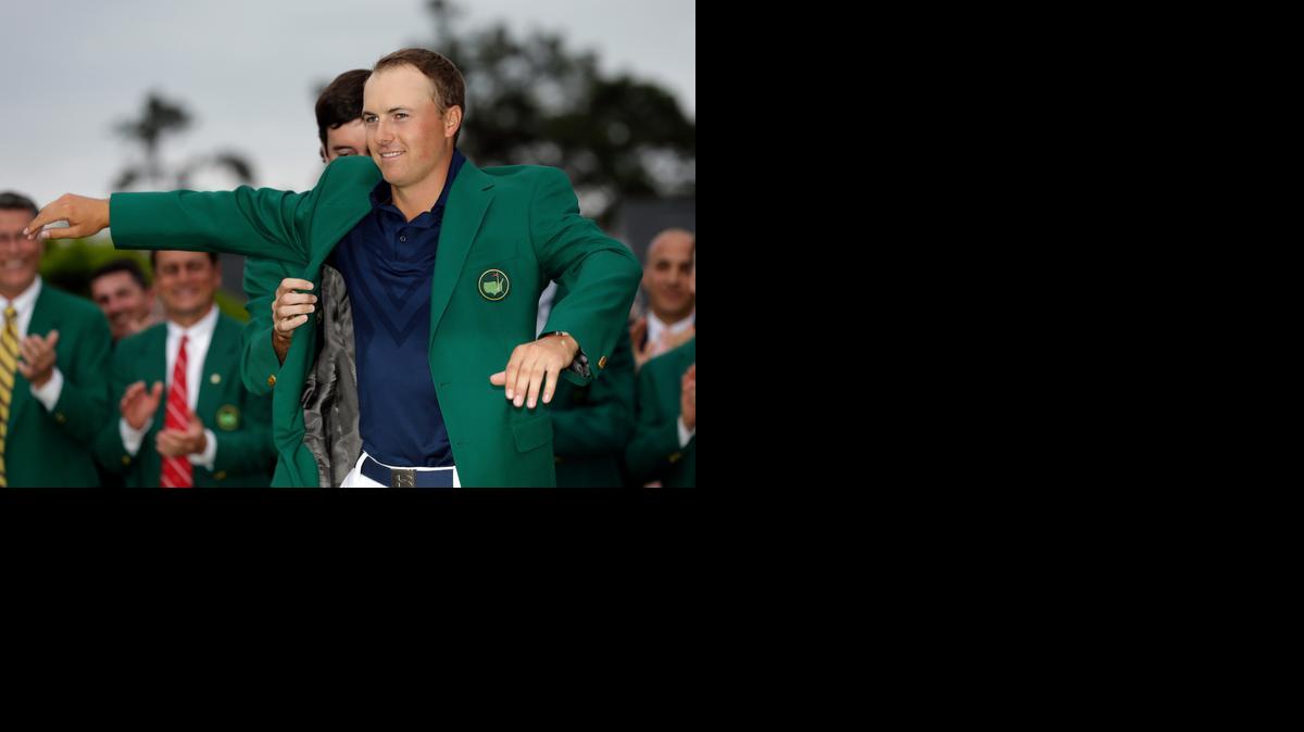 
Bubba Watson helps Jordan Spieth put on his Masters jacket on Sunday night in Augusta, Ga. 

