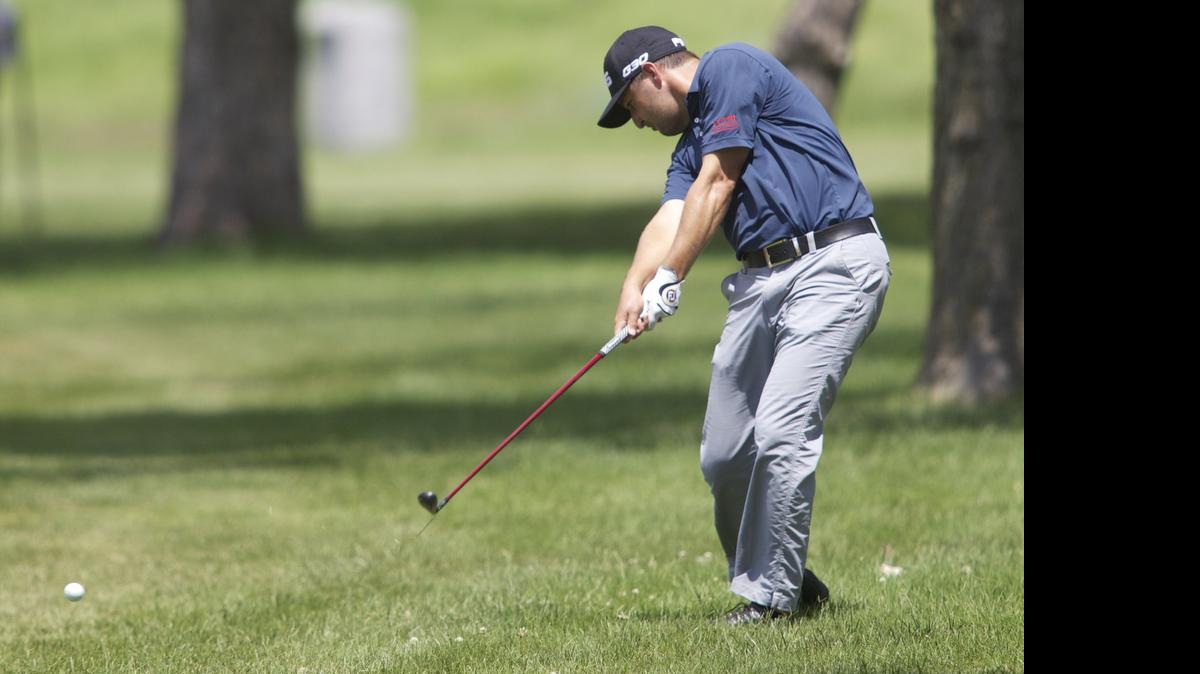 
Rob Oppenheim hits his second shot on No. 18 during the fourth round of the Air Capital Classic at Crestview Country Club Sunday afternoon. Oppenheim shot six under to win the tournament after the leader shot one over par.
