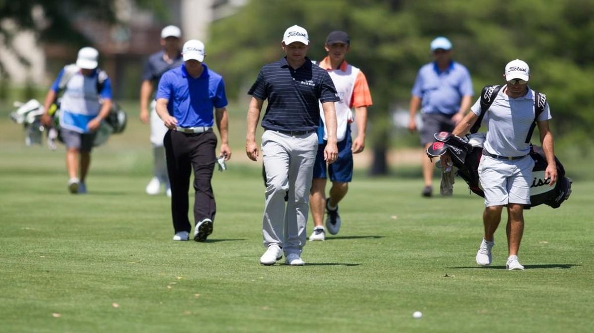 John Merrick walks down down the 16th fairway Thursday at Crestview Country Club during the firt round of the Air Capital Classic.